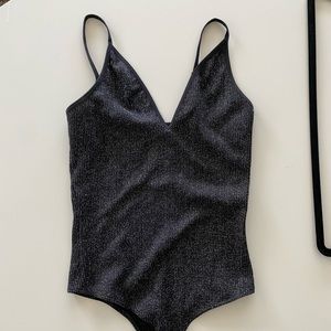 Black and silver body suit. Easy to pair with jeans or a fun skirt.
